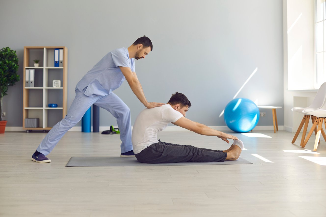 Osteopath Stretching Man Patients Back and Making Rehabilitation Theapy for Patient